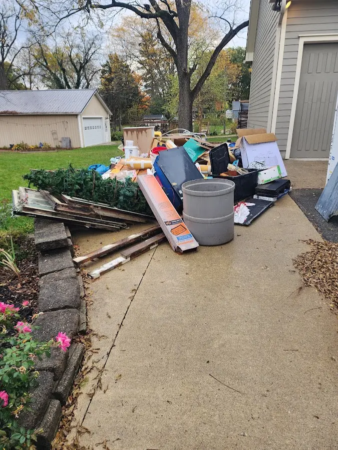 Dumpster being loaded with debris for Estate Cleanout Dumpster Rental in Harwood Heights